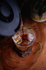 Making refreshing Espresso Tonic, cold-brew tonic on a wooden table