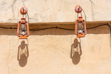 Two lanterns hanging out on the wall in Al Fahidi Historical District in Dubai, UAE