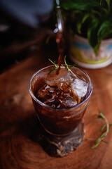 Making refreshing Espresso Tonic, cold-brew tonic on a wooden table