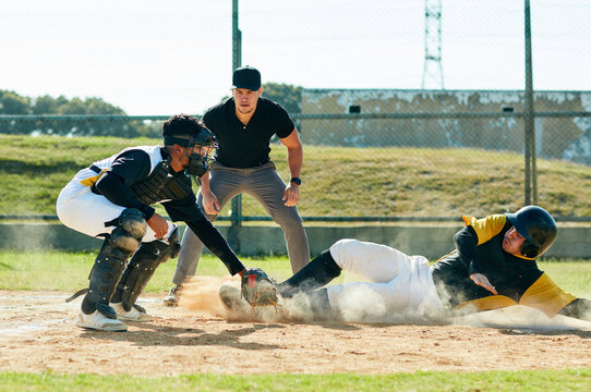 Men, baseball or runner with referee or pitcher for sports, point or match in tournament or outdoor game. Young, male people or players with dust for competition, score or safe on grass field or turf