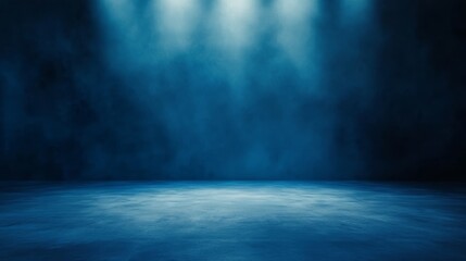 Dramatic blue backdrop illuminated by a single light source, ideal for photography and design projects