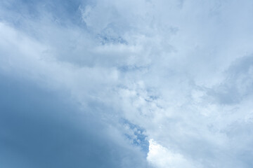 Beautiful cloudscape with fluffy white clouds drifting across a vibrant blue sky