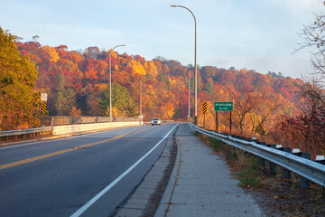 Car crosses a bridge over the Mississippi River in Brainerd Minnesota on a bright fall morning