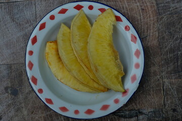 Fried breadfruit on an old zinc plate.
