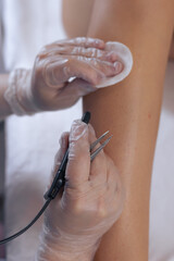 Health professional marking skin for a medical procedure at a clinical setting