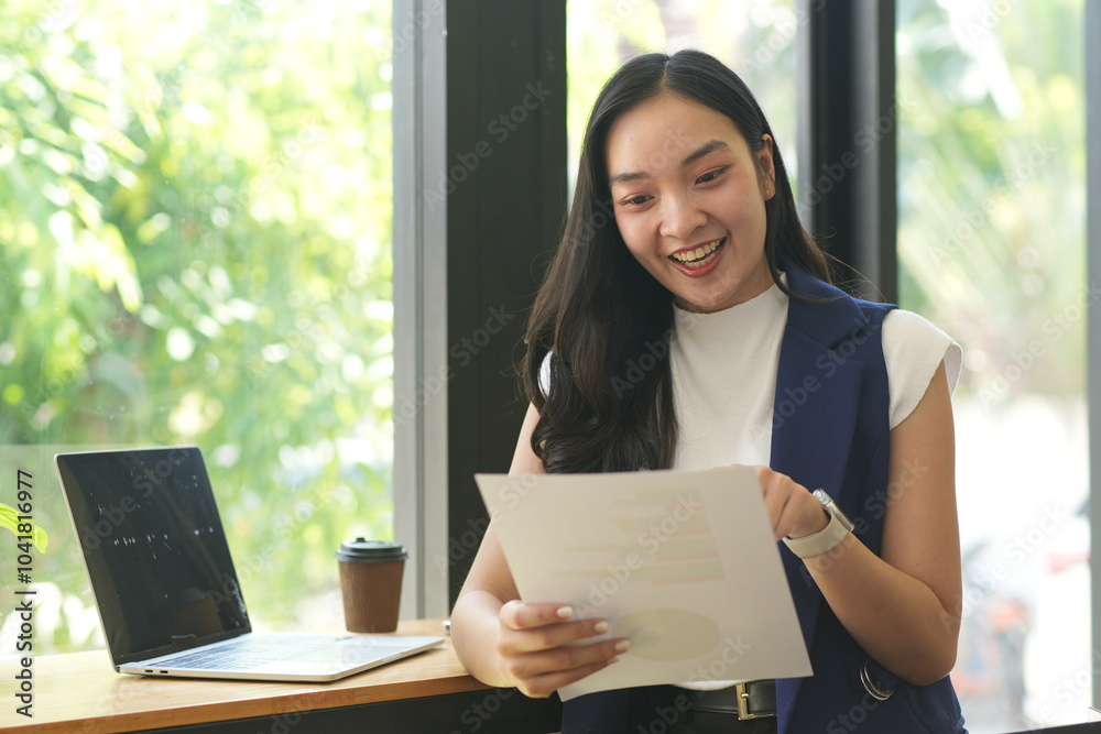 Wall mural asian woman succeeds at office