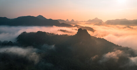 Fototapeta premium Aerial View of Morning fog and mountains as the sun rises from above