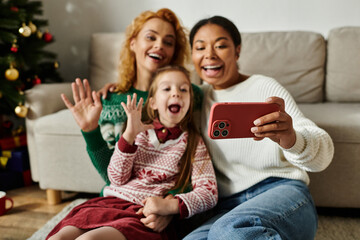 A happy couple and their daughter celebrate together at home, embracing warmth and joy.