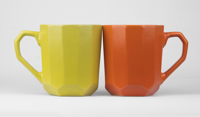 ceramic mugs in vibrant yellow and orange 