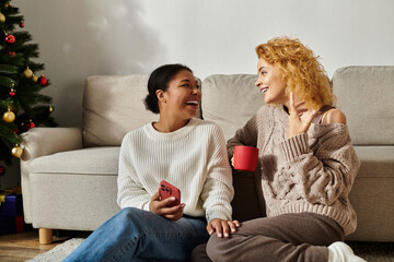 Two joyful partners enjoy each others company while relaxing at home in a warm atmosphere.