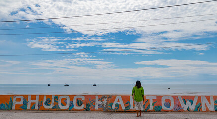 A Girl walks in front of a mural with the word Phuoc Hai Town at in Dat Do District, Bà Rịa–Vũng Tàu province, Vietnam. © Lam Charles