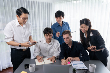 Group of diverse office worker employee working together on strategic business marketing planning in corporate office room. Positive teamwork in business workplace concept. Prudent