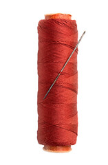Thread bobbin and needle on white background