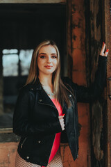 Edgy young woman in a grunge outfit at an abandoned building