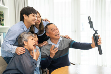Family selfie with grandparents and children taking photo together at home, fun family activity, senior man with children, technology in family joyful expressions, happy family memories
