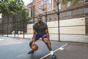 African american basketball player training outdoors - Sportive man playing basketball on a outdoor...