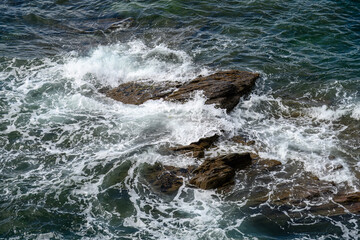 waves splashing and water spray over the rocks in the sea