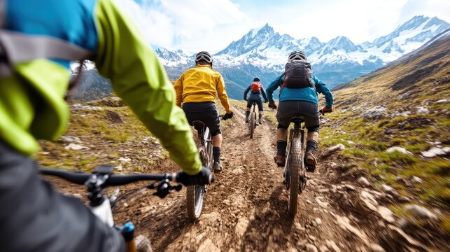 A group of cyclists ride down a gorgeous mountain path, showcasing the blend of nature, sport, and adventure as they explore a scenic outdoor landscape.