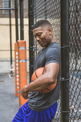 Black sportive basketball player playing basketball on a court in New York City