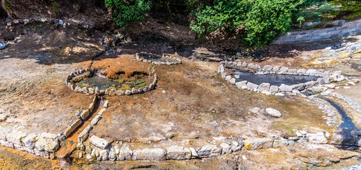 A view looking down on fumarole craters in the town of Furnas on the island of San Miguel in the Azores in summertime