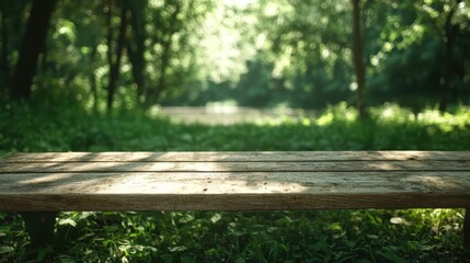 Fototapeta premium An empty park bench is prominently featured against a blurred background of a lush forest in daylight, inviting relaxation and the enjoyment of nature's tranquility.