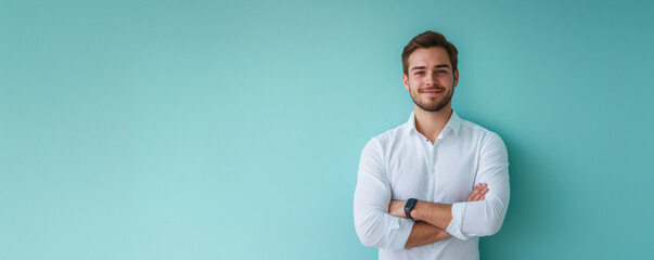 Handsome smiling man in white shirt on pastel light blue background, wide copyspace banner