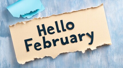 A torn yellow paper displays the friendly greeting Hello February, creating a vibrant contrast with the blue background, welcoming the new month