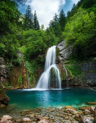 Fototapeta premium Waterfall cascading into pool