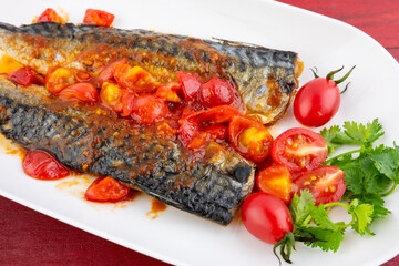 A plate of mackerel with tomato and sweet and sour sauce