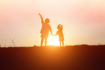 Fototapeta premium kid silhouette,Moments of the child's joy. On the Nature sunset