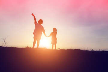 Fototapeta premium kid silhouette,Moments of the child's joy. On the Nature sunset