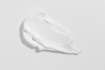 White beauty cream smear smudge on white background. Cosmetic skincare product texture. Face cream,...