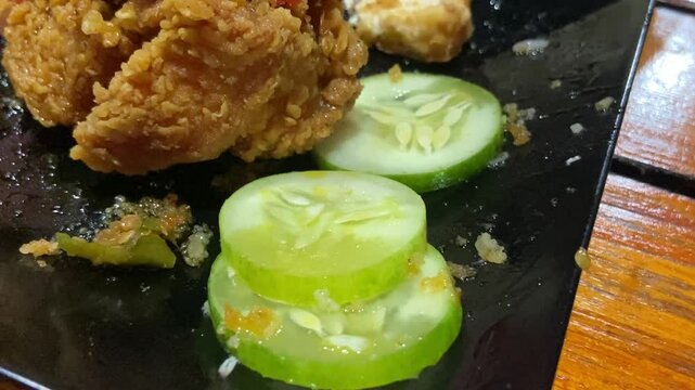Eating "Ayam Geprek" Indonesian Traditional Food with chili Suce at the restaurant