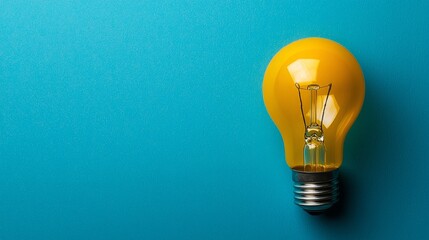 Close-Up of Yellow Light Bulb on Vibrant Blue Background