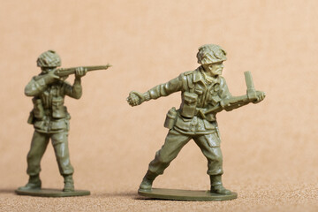 Toy soldier figures (ww2 era uniforms), green plastic, one providing covering fire, the other...