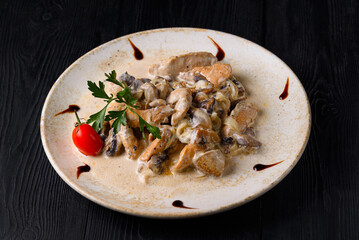 mushrooms with chicken meat in sauce with cherry tomatoes and herbs