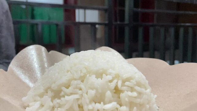 Eating "Ayam Geprek" Indonesian Traditional Food with chili Suce at the restaurant