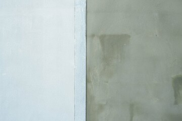 The cement wall has just been plastered and is starting to be painted, backgrounds and texture stock photos.