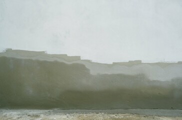 The cement wall has just been plastered and is starting to be painted, backgrounds and texture stock photos.