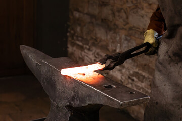 Craftsman - blacksmith who manually forges molten metal with a pair of tongs