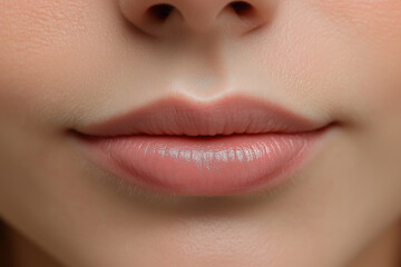Fototapeta premium A woman's face with a pink lip gloss
