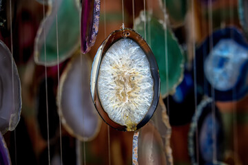 Close-up of hanging ornaments made with agate stones and geodes