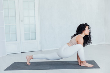 Relaxe harmonious beautiful brunette woman yoga instructor standing in anjaneyasana pose,