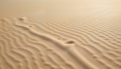 Close-up of a sandy surface with gentle ripples and patterns creating a serene natural atmosphere