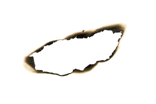 burned hole white paper background texture. Burn in paper with brown edges and flames isolated on a transparent background