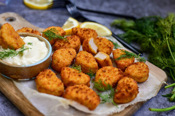 Crispy  deep fried   chicken  popcorn  nuggets and french fries . Breaded  with Cornflakes chicken  Breast fillets  with chilly peppers and fresh   basil on wooden rustic background