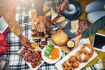 Friends, picnic and hands of people with food on holiday, vacation and adventure outdoors. Travel, weekend and above of men and women with snack, meal and fruit on blanket for bonding, relax and fun