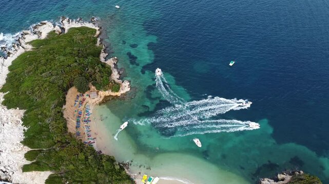 Ksamil Islands, tourist recreation spot in Albania. Rocky islands with sandy beach and boats. Aerial