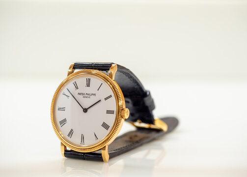 BANGKOK - SEPTEMBER 12 : Patek Philippe Calatrava, ultra luxury watch, model 5120, full gold case with hobnail bezel, thin alligator strap with gold buckle, put on white table in Bangkok, Thailand