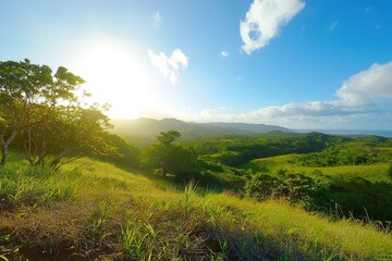 Obraz premium Sunrise over lush green hills with vibrant skies in a tranquil tropical landscape